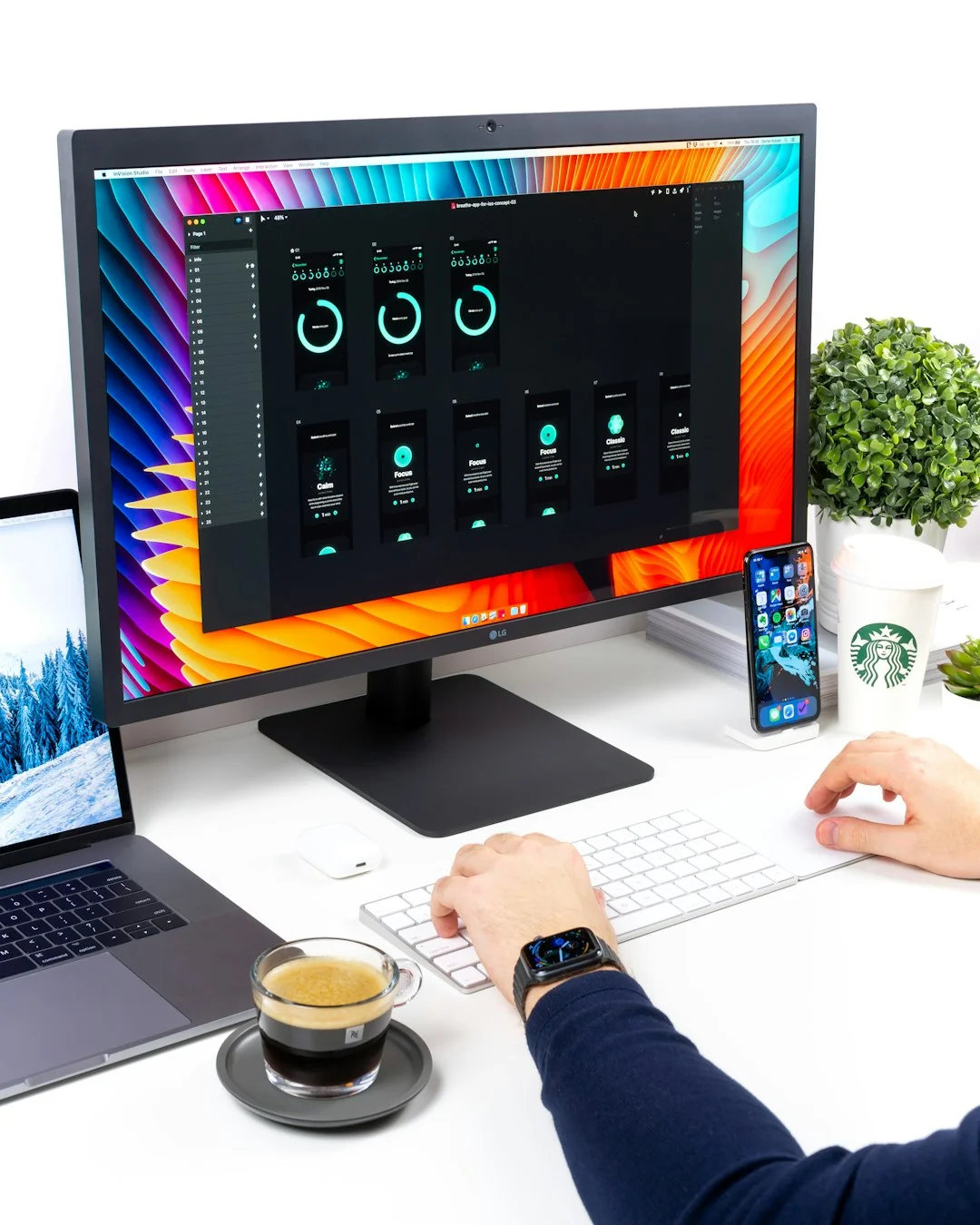 Dual monitors on a desk, showcasing web design in a modern office setting.